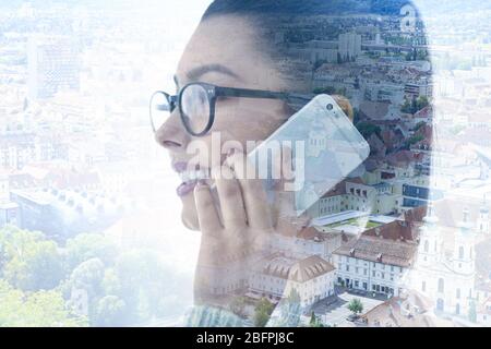 Management concept. Double exposure of business woman talking on phone and cityscape background Stock Photo