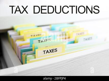 Tax deductions concept. Folders with files in drawer, closeup Stock Photo