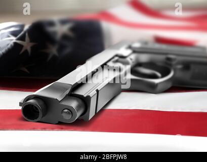 Firearm lying on American flag. Gun control concept Stock Photo