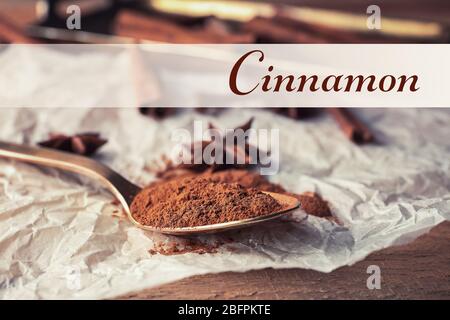Spoon with powdered cinnamon on paper Stock Photo