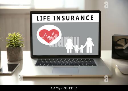 Modern laptop on table. Life insurance concept Stock Photo