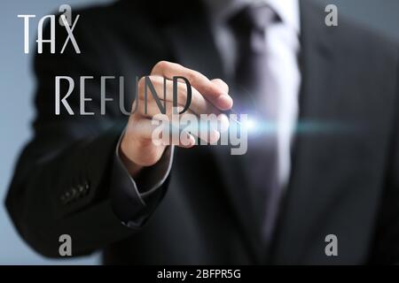 Man working with virtual screen, closeup. Tax refund concept Stock Photo