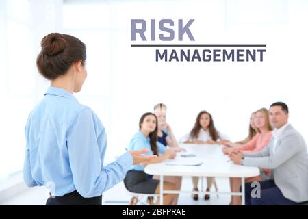 Concept of risk management. Business trainer with team of managers on meeting Stock Photo
