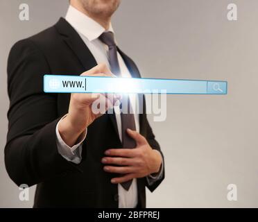 Internet shopping concept. Man clicking on browser search bar, color background Stock Photo