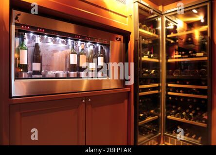 Dispenser and refrigerators with bottles of wine in cellar Stock Photo