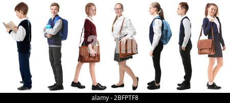 Collage of children in different school uniforms on white background Stock Photo