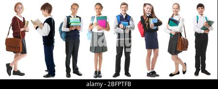 Collage of children in different school uniforms on white background Stock Photo