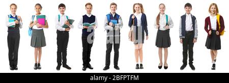 Collage of children in different school uniforms on white background Stock Photo