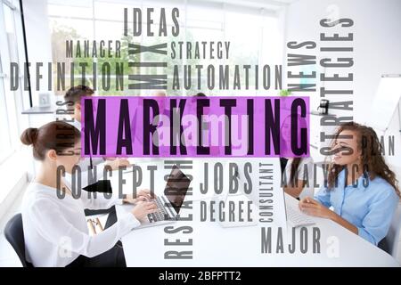 MARKETING word cloud and people in office on background Stock Photo
