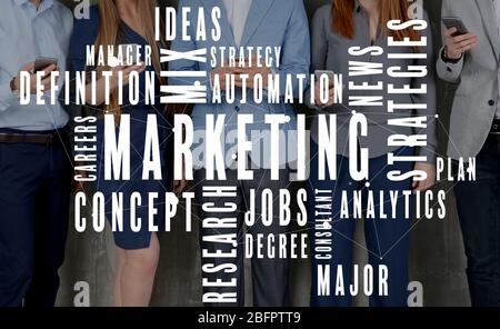 MARKETING word cloud and people with smartphones on background Stock Photo