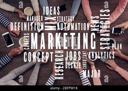 MARKETING word cloud and people with cups of coffee on background Stock Photo