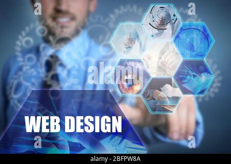 Concept of web design and modern technology. Young man working with virtual screen Stock Photo