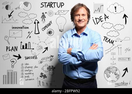 Mature man presenting business ideas on light background. Concept of consulting Stock Photo