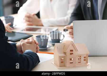 Workers of real estate agency on meeting in office Stock Photo