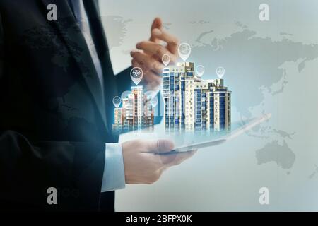 Businessperson holding tablet and media image of futuristic city. Modern technology concept Stock Photo