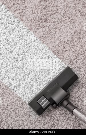 Vacuum cleaner removing dirt from carpet Stock Photo