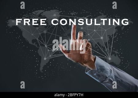 Man working with virtual screen on dark background. Consulting service concept Stock Photo