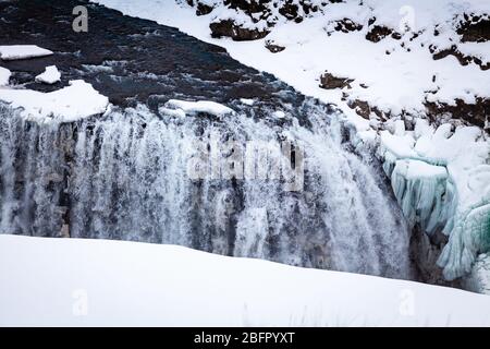 Looking down on the two tier frozen waterfalls at Gullfoss on the Golden Circle tour in Iceland in snow in winter Stock Photo