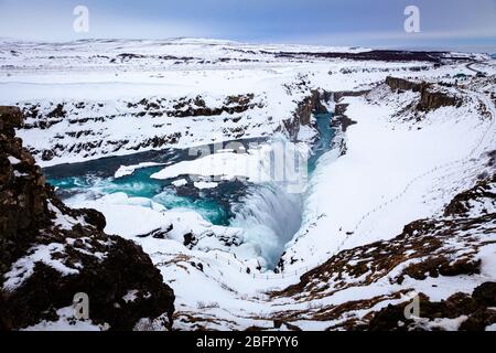 Looking down on the two tier frozen waterfalls at Gullfoss on the Golden Circle tour in Iceland in snow in winter Stock Photo