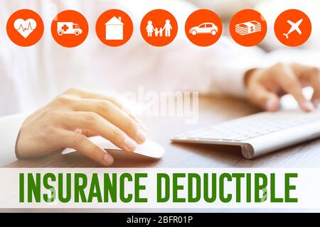 Man using computer at table. Concept of insurance deductible Stock Photo
