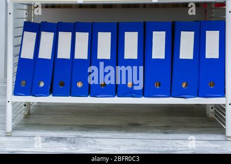 Folders with documents on shelf in archive Stock Photo
