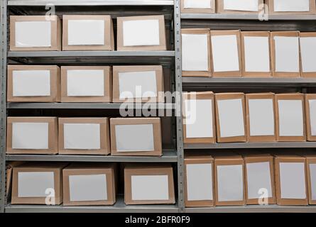 Cardboard boxes with documents on shelving unit in archive Stock Photo