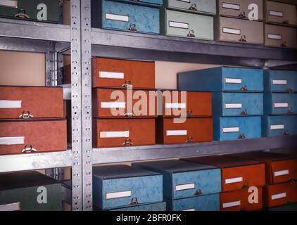 Cardboard boxes with documents on shelving unit in archive Stock Photo