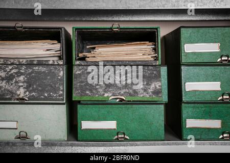 Cardboard boxes with documents on shelving unit in archive Stock Photo