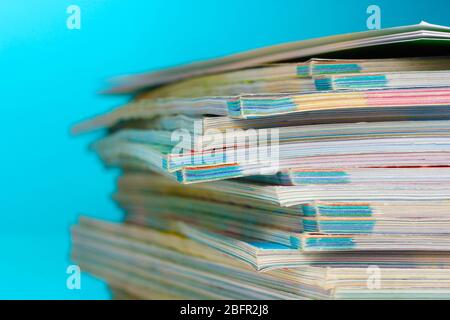 stack of magazines on blue background Stock Photo