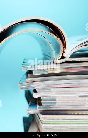 stack of magazines on blue background Stock Photo
