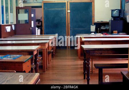 Empty Classroom with Wooden tables, Benches and Blackboard Stock Photo