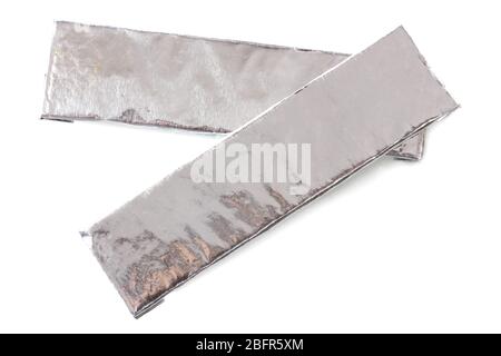two chewing gums wrapped in standard silver foil, isolated on white Stock Photo