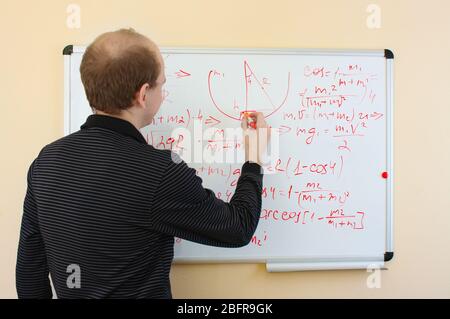 Man draw science formulas Stock Photo - Alamy