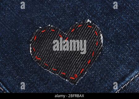 Heart-shaped patch on jeans closeup Stock Photo