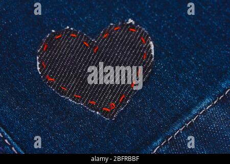 Heart-shaped patch on jeans closeup Stock Photo