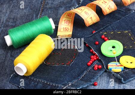 Heart-shaped patch on jeans with threads and buttons closeup Stock Photo