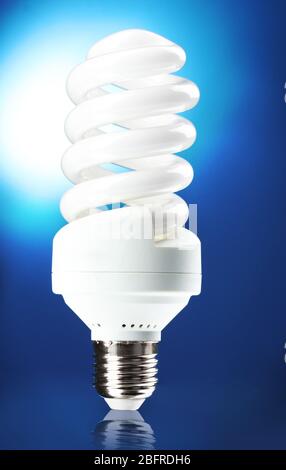 Energy saving lamp on blue background Stock Photo