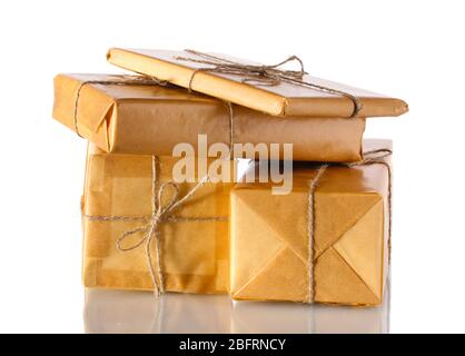 Many parcels wrapped in brown paper tied with twine isolated on white Stock Photo