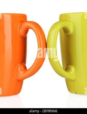 Two colored cups handles close-up isolated on white Stock Photo