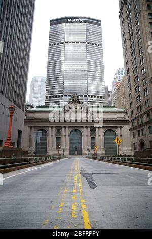 The roadway on Park Avenue leading through Grand Central Terminal is nearly empty of traffic due to health concerns to stop the spread of Coronavirus Stock Photo