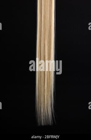 Shiny blond hair isolated on black Stock Photo