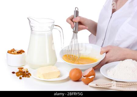 Female hands mixing eggs in bowl isolated on white Stock Photo