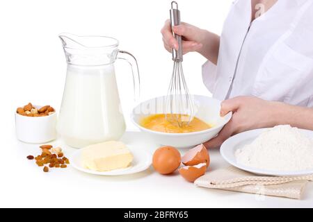 Female hands mixing eggs in bowl isolated on white Stock Photo