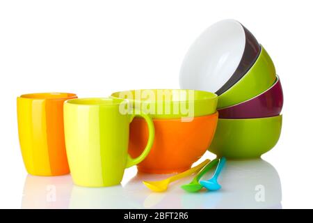 bright empty bowls, cups and spoons isolated on white Stock Photo