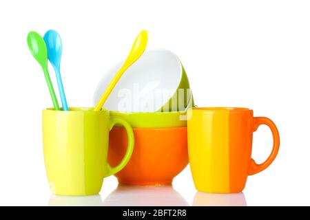 bright empty bowls, cups and spoons isolated on white Stock Photo