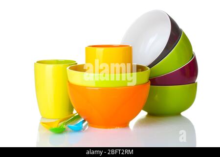 bright empty bowls, cups and spoons isolated on white Stock Photo