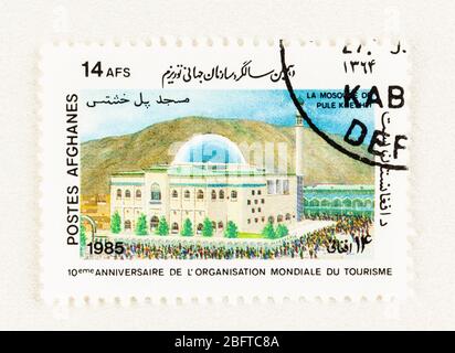 SEATTLE WASHINGTON - April 18, 2020: Afghanistan Postage stamp featuring Pule Kheshti Mosque and devotees, commemorating the 10th Anniversary of World Stock Photo