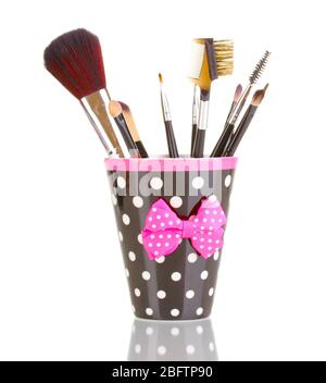 Makeup brushes in a black polka-dot cup isolated on white Stock Photo