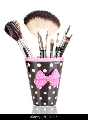 Makeup brushes in a black polka-dot cup isolated on white Stock Photo