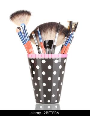 Makeup brushes in a black polka-dot cup isolated on white Stock Photo